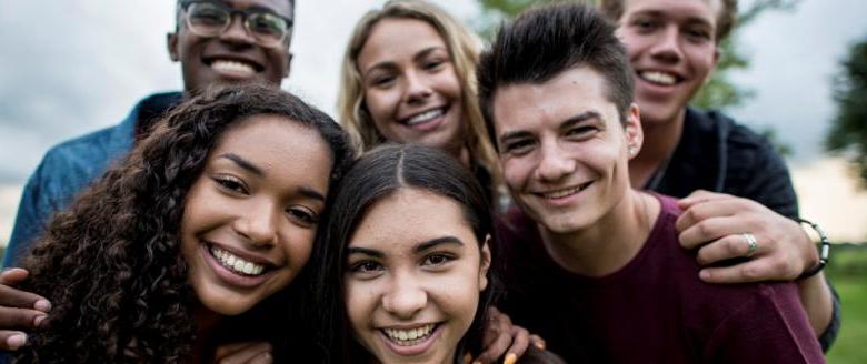 Group of multicultural teens smiling and looking at camera